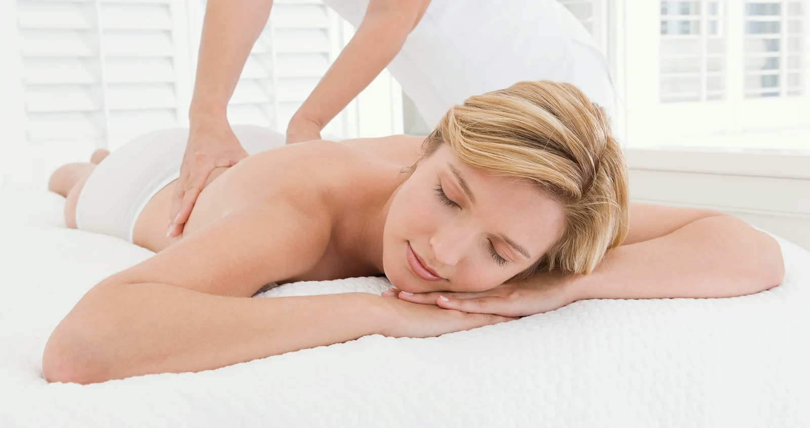 Client relaxing on a massage table during a session